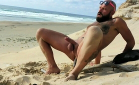 tattooed-guy-drills-his-ass-and-jerks-his-cock-on-the-beach